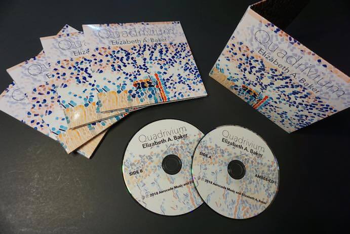 Quadrivium double compact disc set with 16-page zine of artwork and poetry by Elizabeth A. Baker. 