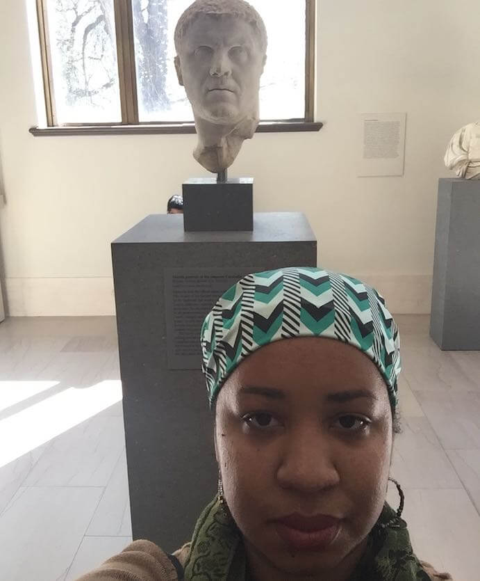 Courtney Bryan at the MET museum in NYC with a bust of Caracalla