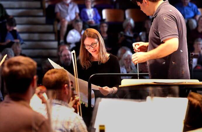 Anna Clyne confers with Cabrillo Musical Director Cristian Macelaru during an open rehearsal of Clyne's "DANCE for Cello and Orchestra"--Photo by RR Jones, Courtesy of the Cabrillo Festival of Contemporary Music