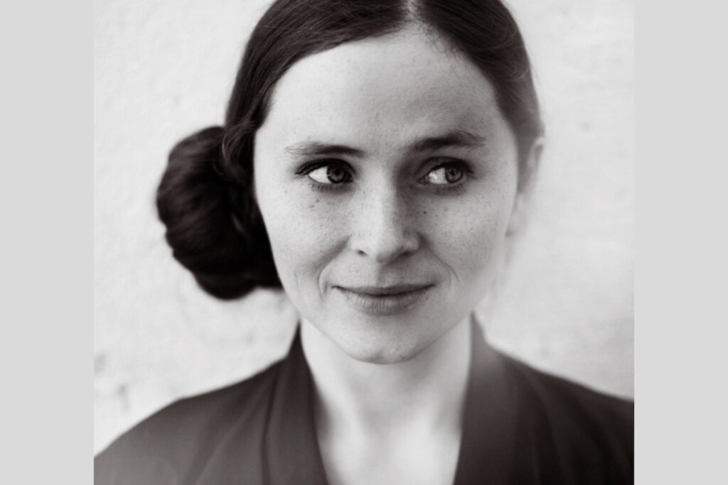 Black and white image of a brown haired woman facing the camera, looking off to the lower right side, Dark Music Days 2026 -- Photo by Rut Sigurdardottír
